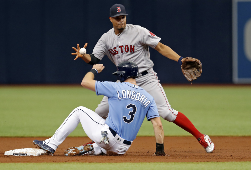 Boston shortstop Xander Bogaerts bobbles the exchange after forcing out Tampa Bay's Evan Longoria during the Rays' 5-3 win Sunday in St. Petersburg, Florida.