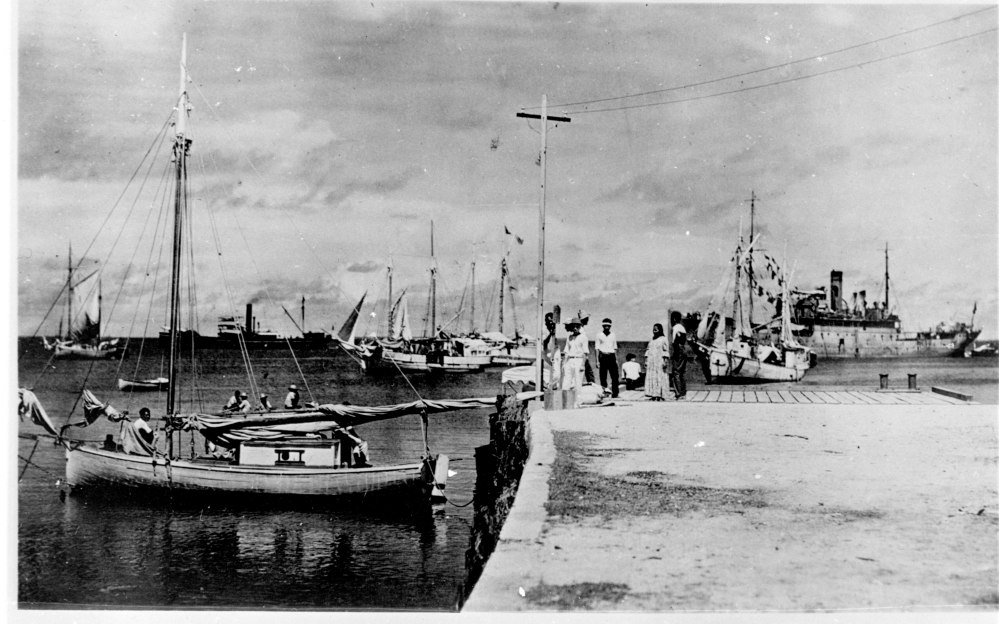 This photo discovered in the National Archives shows people on a dock in Jaluit Atoll, Marshall Islands. A new documentary proposes that the image shows aviator Amelia Earhart, seated third from right, gazing at what may be her crippled aircraft loaded on a barge. The documentary, "Amelia Earhart: The Lost Evidence," aired Sunday on the History Channel.