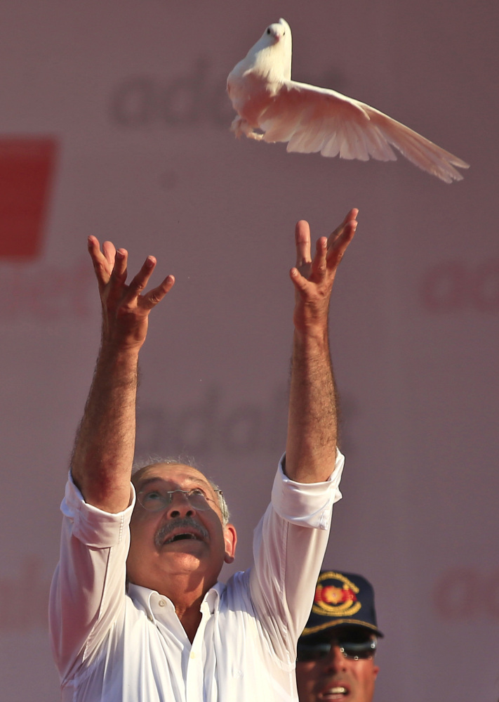 Kemal Kilicdaroglu, the leader of Turkey's main opposition Republican People's Party, throws a dove into the air during a rally following his 425-kilometer (265-mile) 'March for Justice' in Istanbul, Sunday, July 9, 2017. Kilicdaroglu along with thousands of supporters walked from the capital Ankara to an Istanbul prison, began to denounce the imprisonment of a party lawmaker but has grown into a wider protest of Turkey's President Recep Tayyip Erdogan's policies and the large-scale government crackdown on opponents in the wake of July 2016's failed coup attempt. (AP Photo/Lefteris Pitarakis)