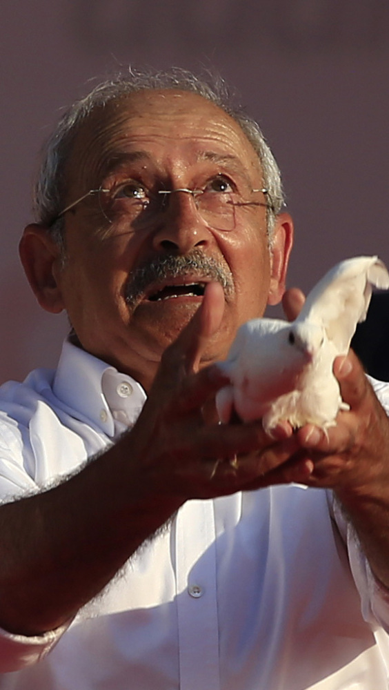 Kemal Kilicdaroglu, the leader of Turkey's opposition Republican People's Party, throws a dove into the air at a rally.
