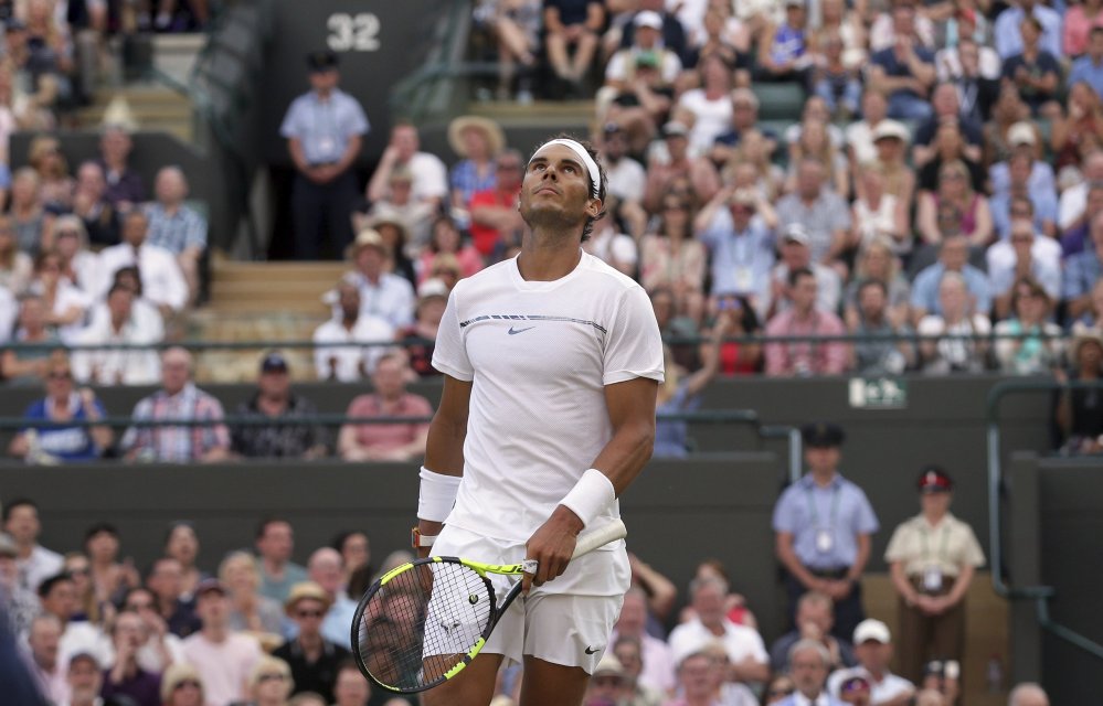 Spain's Rafael Nadal looks up as he plays Luxembourg's Gilles Muller during their fourth-round match at the Wimbledon Tennis Championships in London on Monday. Muller won the match 6-3, 6-4, 3-6, 4-6, 15-13 (AP Photo/Tim Ireland)