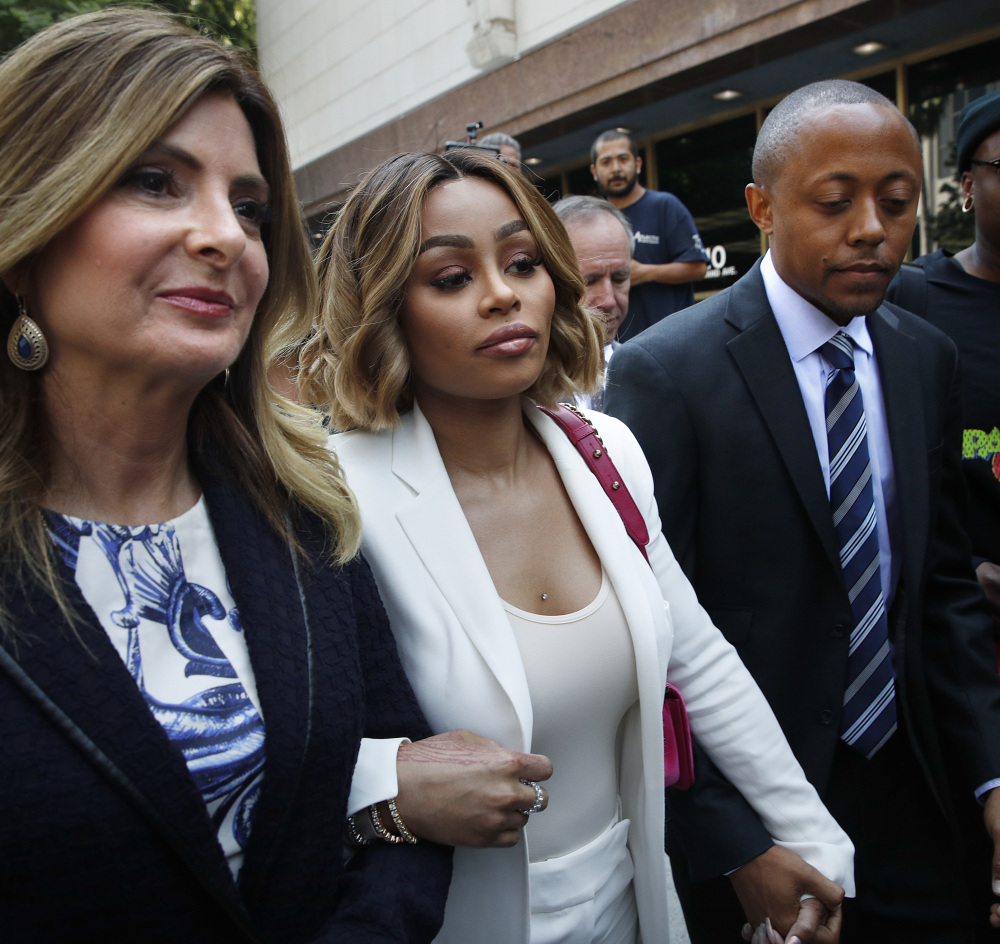Blac Chyna, center, is flanked by her attorneys, Lisa Bloom, left, and Walter Mosley as she leaves court after a hearing Monday.