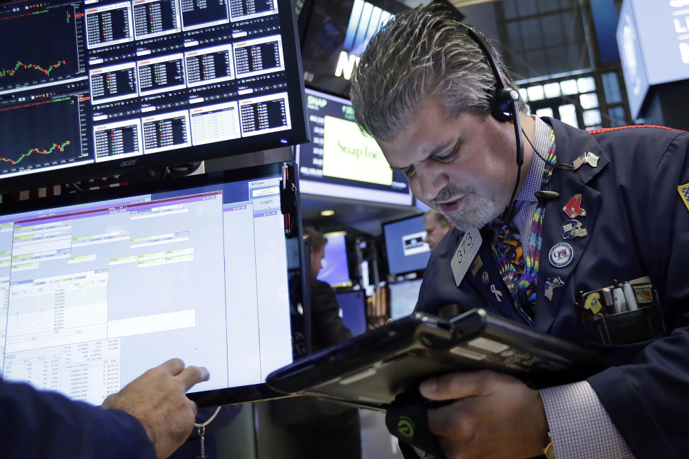 Trader John Panin works on the floor of the New York Stock Exchange, Wednesday, July 12, 2017. Stocks are opening solidly higher on Wall Street, led by gains in technology companies. ()