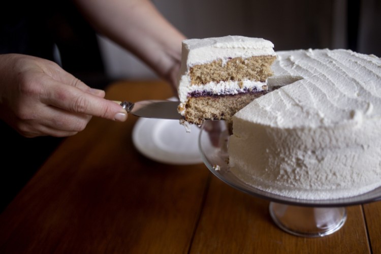 Christine Burns Rudalevige takes a piece of an old-fashioned spice cake with blueberry jam and whipped cream frosting.