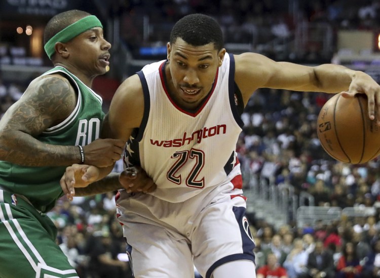 FILE - In this May 4, 2017 file photo, Washington Wizards forward Otto Porter Jr. (22) drives against Boston Celtics guard Isaiah Thomas (4) during the first half in Game 3 of a second-round NBA playoff series basketball game in Washington. The Washington Wizards have matched the Brooklyn Nets' $106 million, four-year offer sheet to keep forward Otto Porter.  (AP Photo/Andrew Harnik, File)