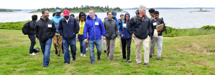 Colby College President David Greene and incoming Colby students walk on the Up East Inc. foundation grounds Thursday on the Wyeth family's Allen Island. The group of students spent a week on the island learning to use equipment to monitor marine ecology.