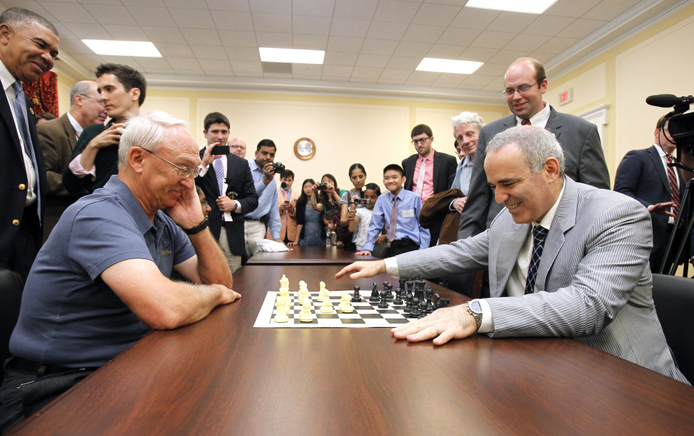 Garry Kasparov, right, and Rex Sinquefield, president of the Board of Directors of the St. Louis Chess Club, play at the Congressional Chess Match of 2014 in Washington.