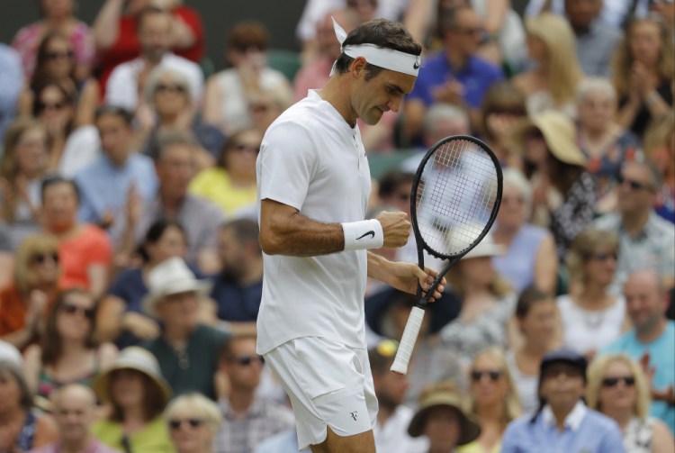 Switzerland's Roger Federer clenches his fist after winning the first set over Croatia's Marin Cilic. Federer went on to win his record eighth men's singles Wimbledon title.