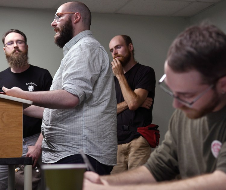 Jeremy Claywell, right, takes notes Sunday during a presentation by members of the Maine John Brown Gun Club during a meeting of the budding Socialist Party of Maine in Augusta.