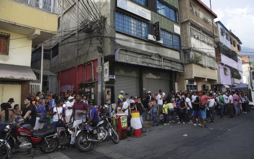 Opposition members line up at a polling station Sunday during a symbolic referendum in Caracas, Venezuela. Venezuela's opposition called for a massive turnout Sunday in a symbolic rejection of President Nicolas Maduro's plan to rewrite the constitution.