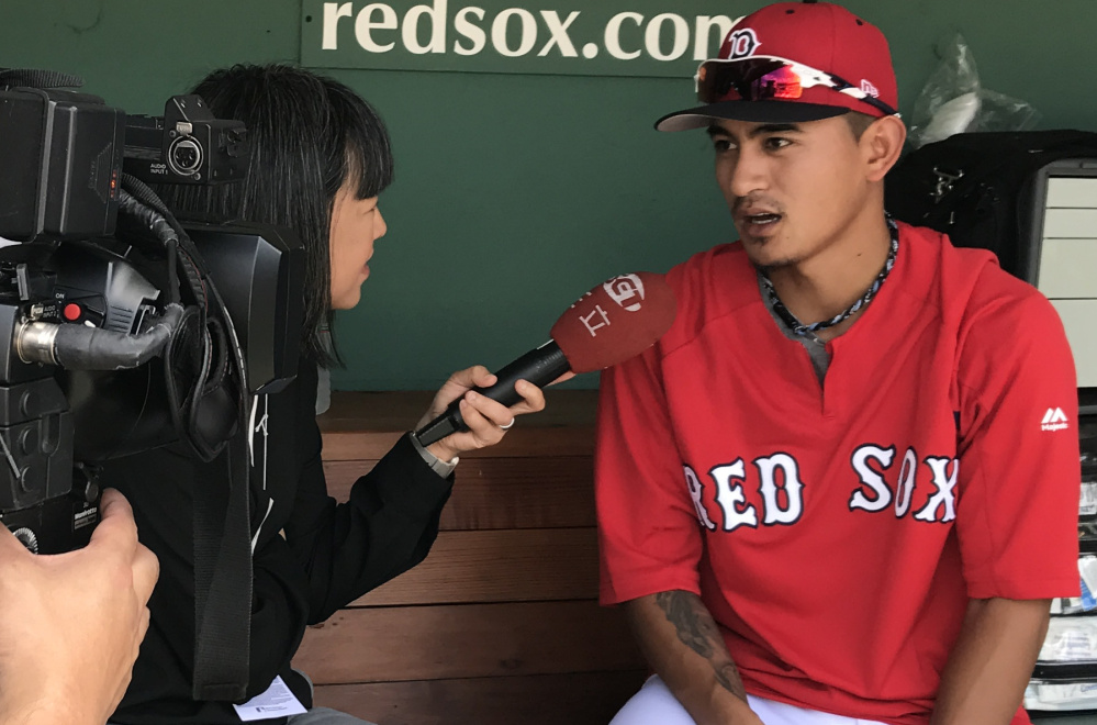 Tzu-Wei Lin talks with a reporter prior to the first game of Boston's doubleheader Sunday against the Yankees. Lin is currently the only active player from Taiwan in the majors.