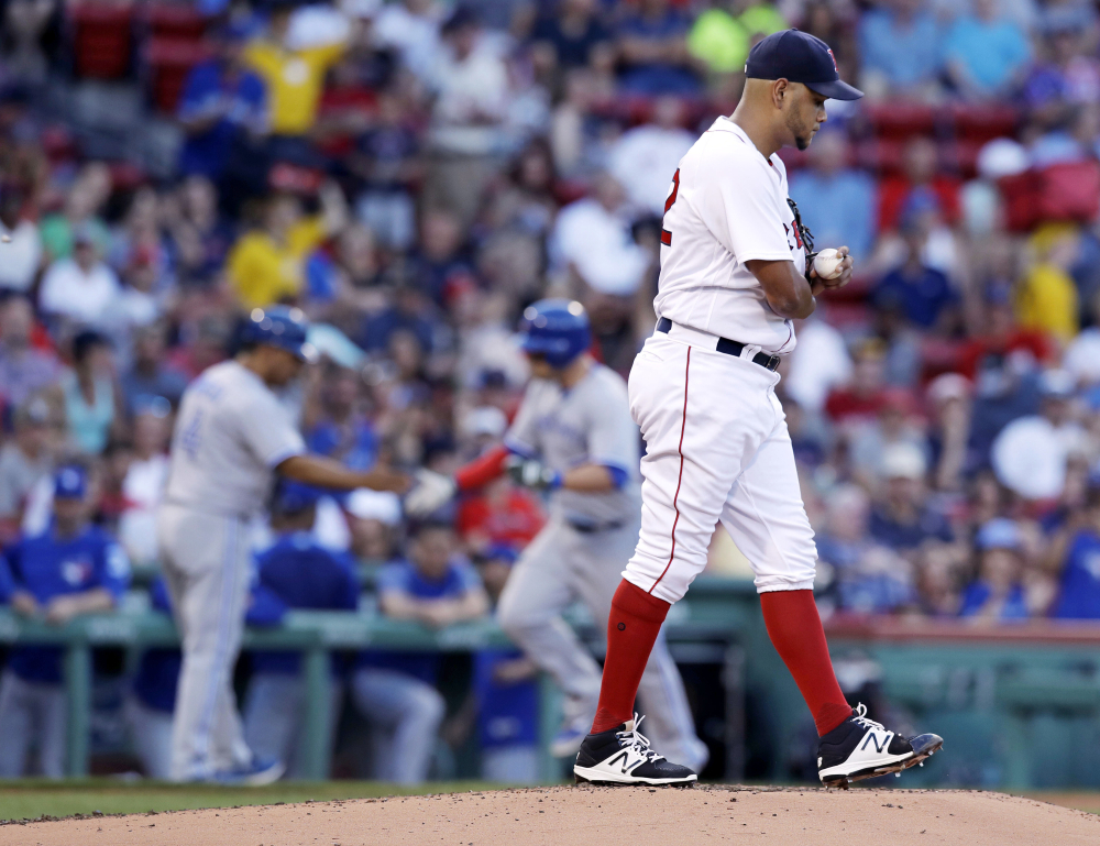 Red Sox starter Eduardo Rodriguez walks to the mound with a fresh baseball as the Blue Jays' Steve Pearce rounds the bases on a solo home run in the second inning. It was the last run that Rodriguez gave up.