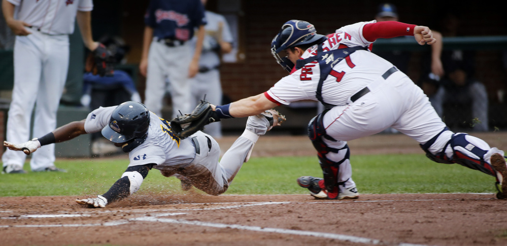 Jorge Mateo of the Trenton Thunder is tagged out by Sea Dogs catcher Jordan Procyshen as he tries to score in the third inning Monday night at Hadlock Field. Trenton scored four runs in the sixth to rally for a 4-3 win.