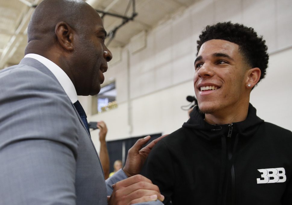 Magic Johnson, left, wants some of the pressure off rookie Lonzo Ball, right, saying the team is not about him. But for fans at the summer league, it is all about Ball. Period.