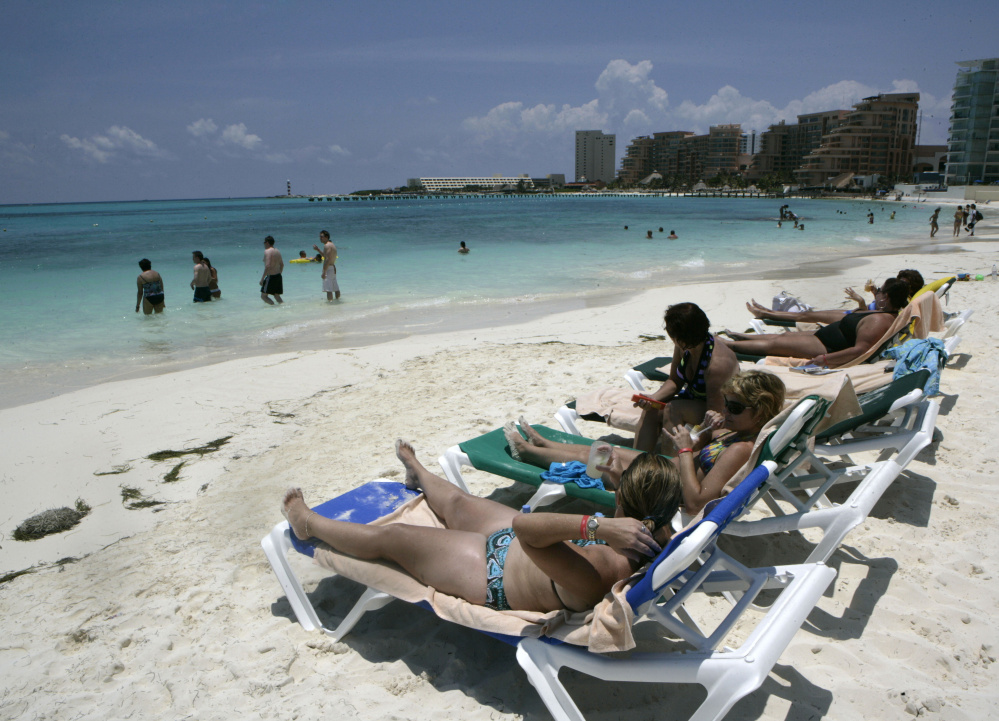 Tourists soak up the sun in Cancun, Mexico. The job market in Mexico is strong this year, and tourism is a factor.