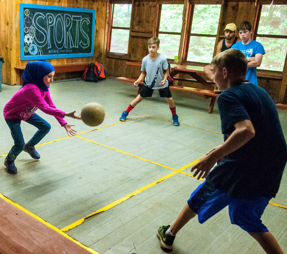 Ghadeer Najar plays four square Wednesday at Camp KV in Readfield. Fifteen refugee children from the Augusta area have been able to participate in the summer fun.