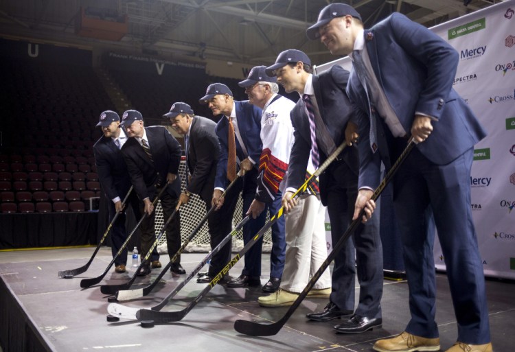 Officials from the ECHL and Cross Insurance Arena pose after a news conference Thursday at the arena, where they announced plans for Portland's new pro hockey franchise.