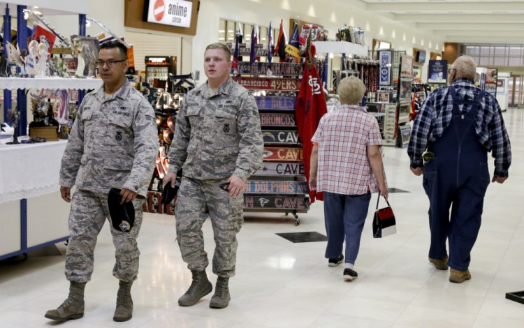 Members of the military and civilians with shopping privileges walk through the Exchange at Offutt Air Force Base, Neb. Starting in the fall, honorably discharged veterans will be able to shop tax-free online at the Exchange with the same discounts they enjoyed at base stores.