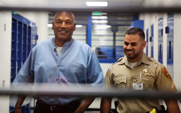 Above, O.J. Simpson is all smiles as he's escorted by a correctional officer for his parole hearing Thursday in Lovlock, Nev., just as he was all smiles when acquitted of a double-murder charge in 1995 with the help of a top-notch defense team that included attorneys F. Lee Bailey, left, and the late Johnnie Cochran Jr.