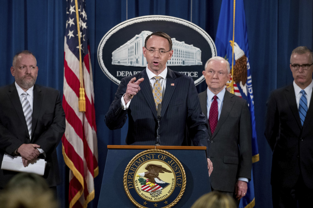 Deputy Attorney General Rod Rosenstein, center, accompanied by DEA Deputy Administrator Robert Patterson, left, Attorney General Jeff Sessions, second from right, and FBI Acting Director Andrew McCabe announce an international cybercrime enforcement action Thursday at the Department of Justice in Washington, D.C.