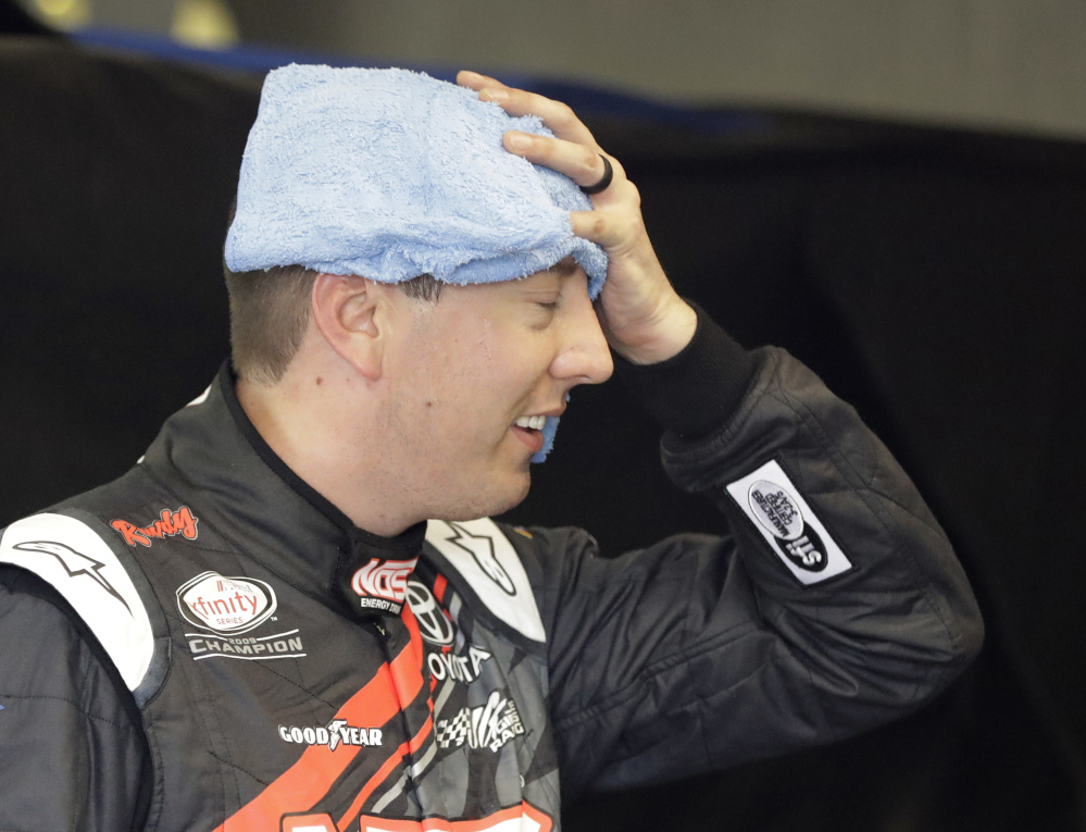 Kyle Busch tries to cool down following a practice session for Saturday's Xfinity Series race at Indianapolis Motor Speedway. Busch swept the Xfinity and Cup Series races each of the previous two years.