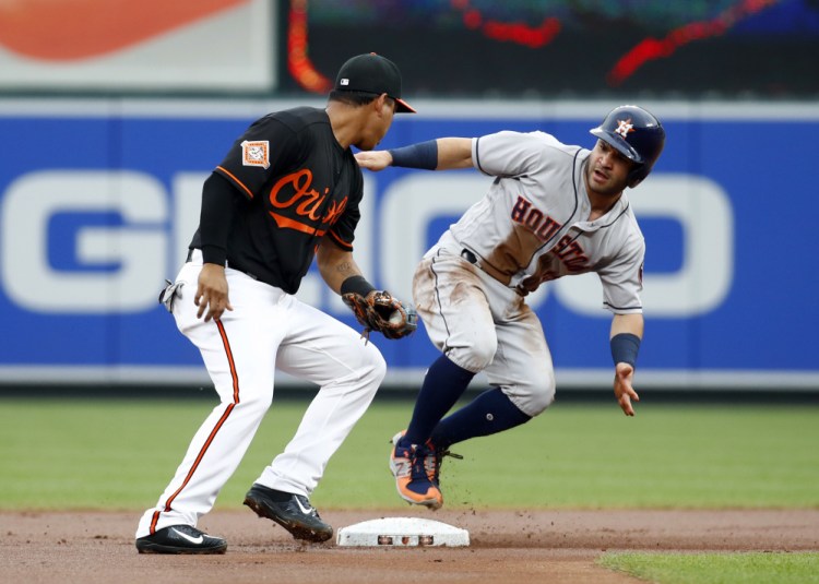Jose Altuve of the Houston Astros, right, steals second base as Ruben Tejada of the Baltimore Orioles takes the throw Friday night in the first inning of Houston's 8-7 victory.