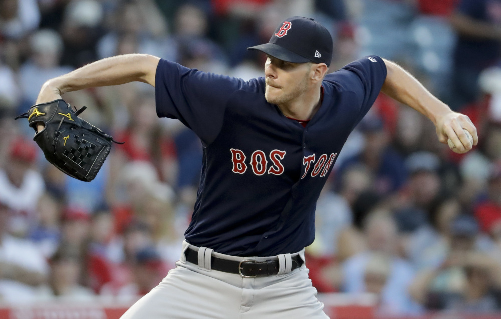 Boston starting pitcher Chris Sale throws against the Angels during the first inning Friday night in Anaheim, Calif. The Red Sox scored five times in the top of the first inning and Sale threw six shutout innings in a 6-2 Boston win.