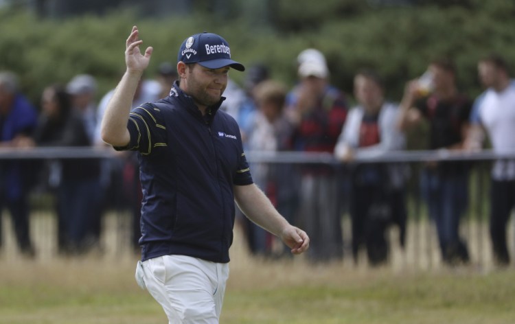 South Africa's Branden Grace waves as he makes his way along the 18th fairway during the third round of the British Open. He shot a course- and major championship record – 62.