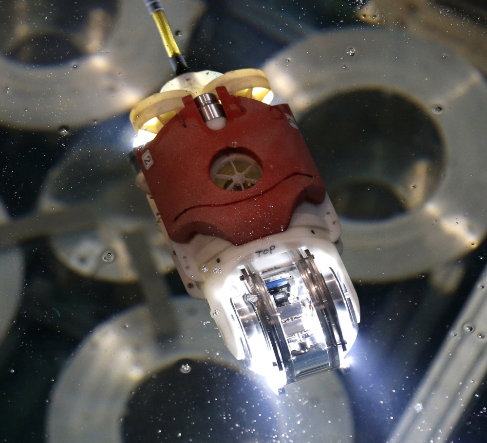 A robot used to probe the Fukushima nuclear reactor moves in the water at a test facility. 