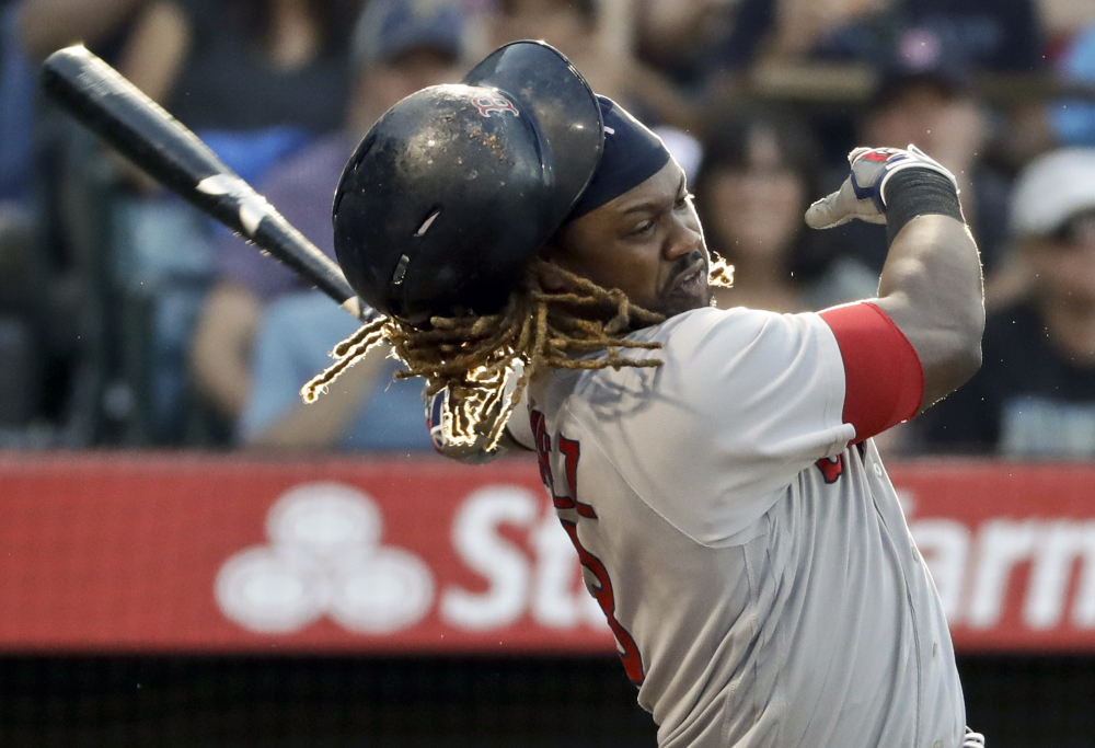Hanley Ramirez loses his helmet while swinging during the Red Sox 7-3 loss at Anaheim on Saturday night.