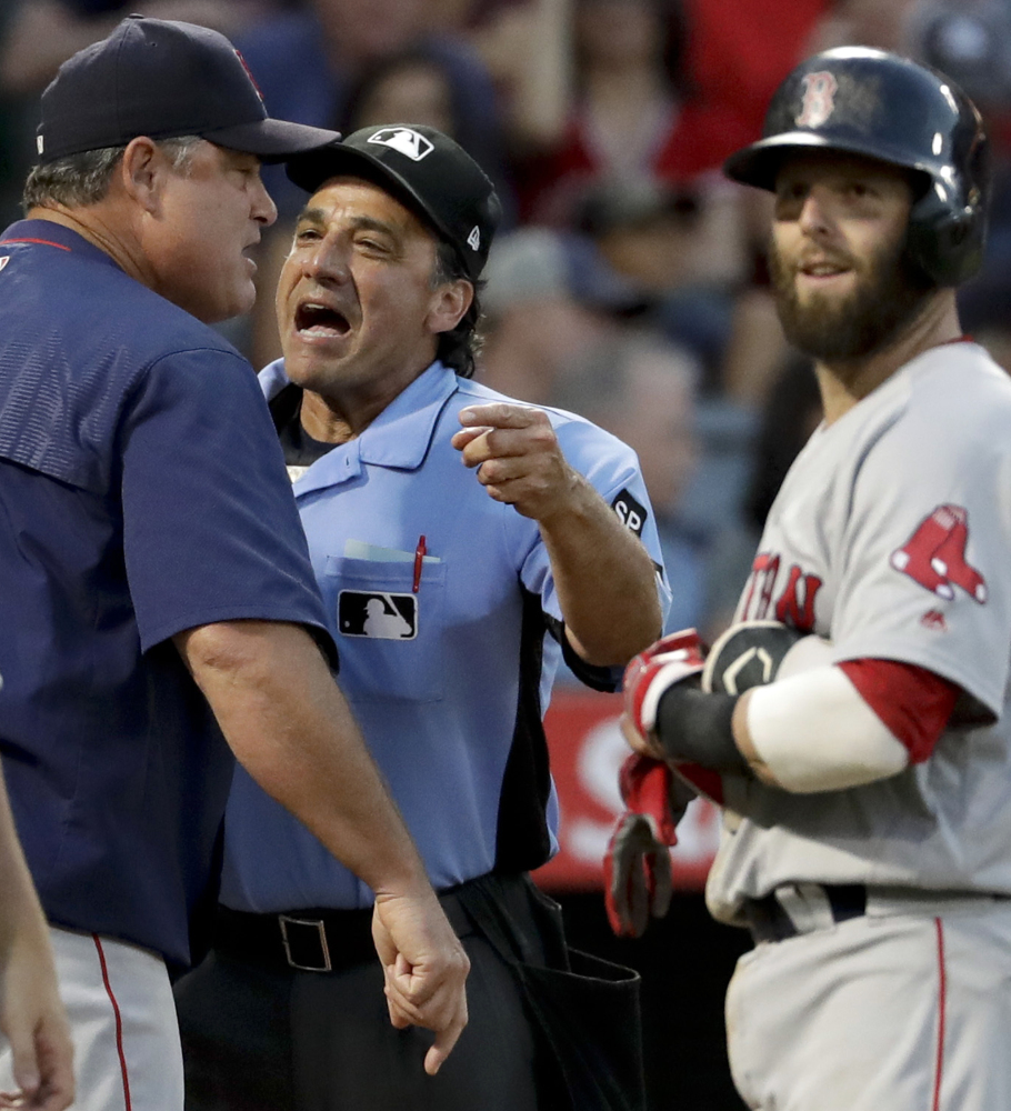 Boston manager John Farrell argues a call with home plate umpire Phil Cuzzi as Dustin Pedroia looks on during the fifth inning Saturday night in Anaheim. The Red Sox lost 7-3.