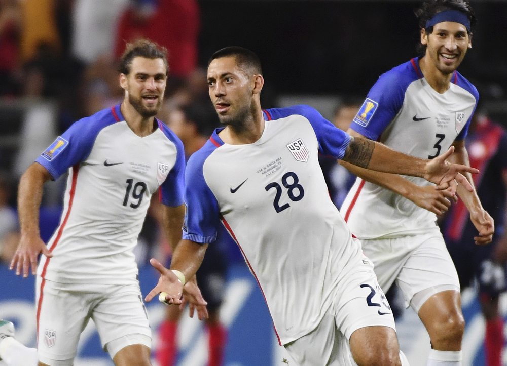 Clint Dempsey celebrates with teammates Graham Zusi, left, and Omar Gonzalez after scoring a goal during a CONCACAF Gold Cup semifinal soccer match against Costa Rica on Saturday night. The U.S. won 2-0 to advance to the Gold Cup finals.