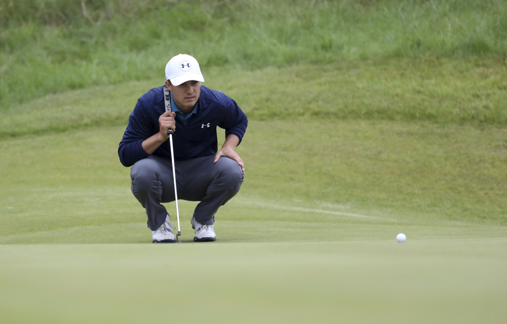 Jordan Spieth lines up a putt on the 14th green during the final round of the British Open on Sunday. Spieth won his first open with a 12-under score for the tournament.