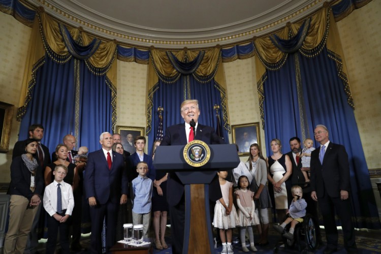 President Trump, accompanied by Vice President Mike Pence, Health and Human Services Secretary Tom Price, and others, speaks about health care Monday at the White House.