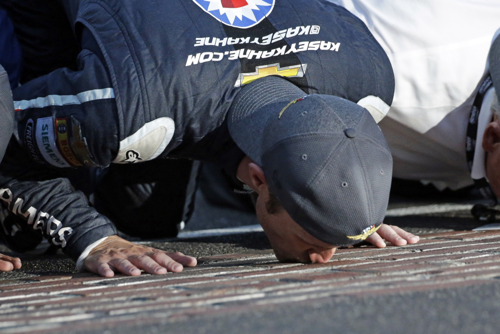 Kasey Kahne (5) kisses the yard of bricks on the start/finish line after winning the NASCAR Brickyard 400 auto race at Indianapolis Motor Speedway in Indianapolis, Sunday, July 23, 2017. (AP Photo/AJ Mast)