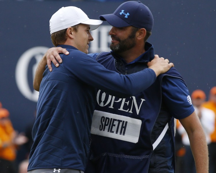 Jordan Spieth celebrates with his caddie Michael Greller after winning the British Open on Sunday. Spieth will go for the career grand slam at the PGA Championship in August.