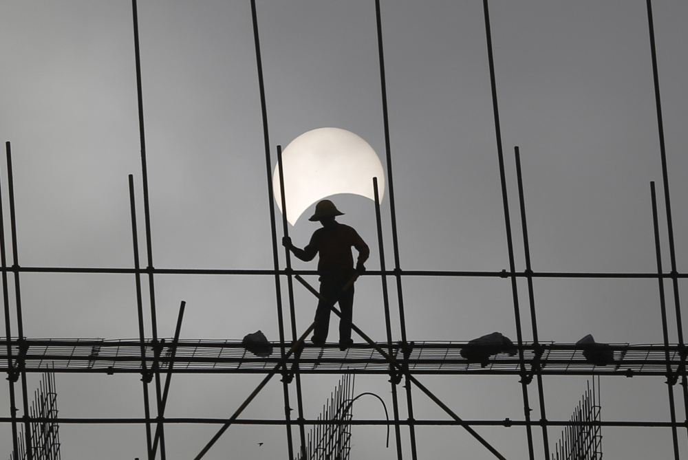 A partial solar eclipse at a construction site in Phnom Penh, Cambodia, on March 9, 2016.
As eclipse chasers get ready for the Great American Eclipse next month,  many hotels along the prime viewing path are already booked solid.