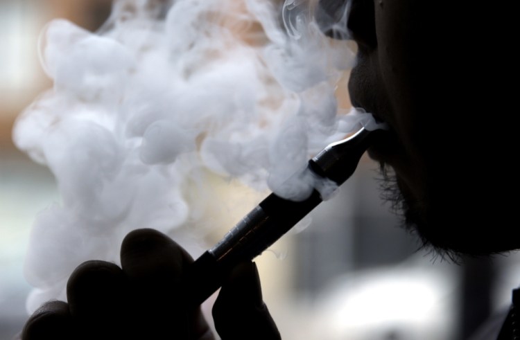 E-cigarette devices heat a liquid nicotine solution into vapor and don't contain all the chemicals and tar of regular cigarettes.