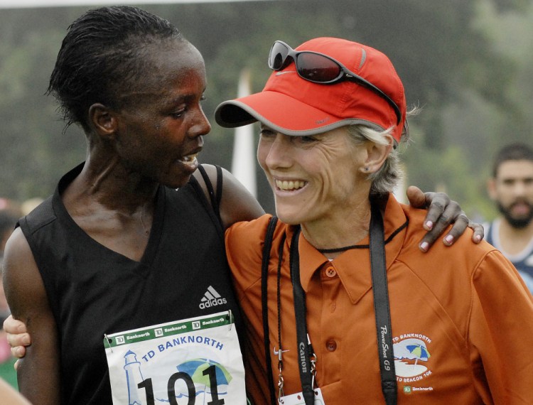 Edith Masai of Kenya is congratulated by Joan Benoit Samuelson after Masai crossed the finish line with the best women's time of the 2008 race by more than seven seconds.