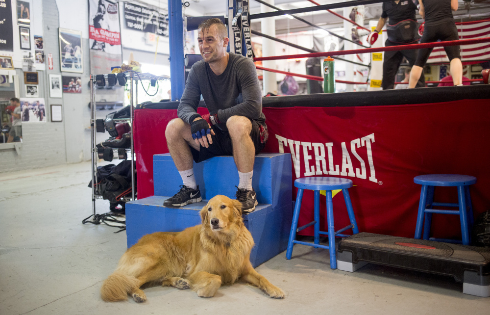 PORTLAND, ME - JULY 27: Jason Quirk rests between rounds with his dog, Abbey, while training for a fight he has on Saturday at the Portland Boxing Club. Quirk, who is from Scarborough, has been training actor Patrick Dempsey in boxing since June. He has been boxing at the Portland Boxing club since he was 15 years old. (Staff photo by Brianna Soukup/Staff Photographer)
