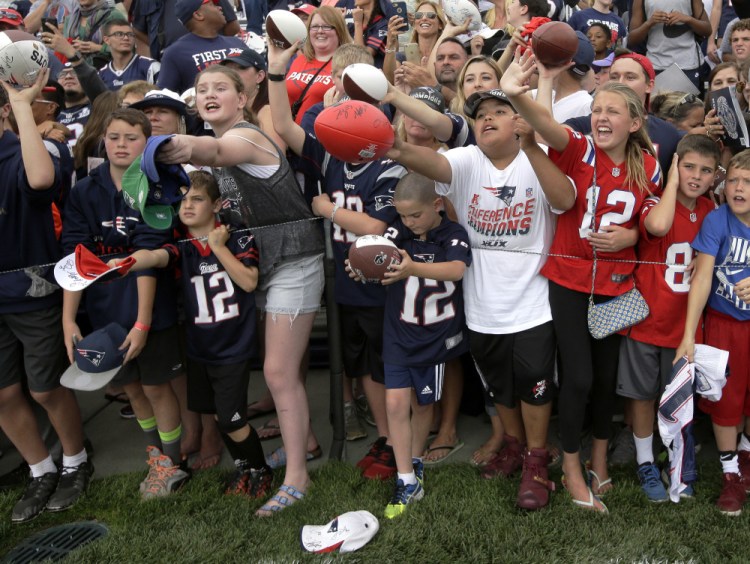 The fans are already clamoring, calling out for autographs from members of the New England Patriots as the players prepare to leave the field after practice Thursday in Foxborough, Mass.