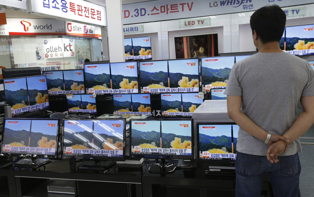 A man watches TV screens in an electronics shop showing a news program's report on North Korea's missile firing in Seoul, South Korea, this month. North Korea fired a ballistic missile Friday night, which landed in the ocean off Japan, Japanese officials said.