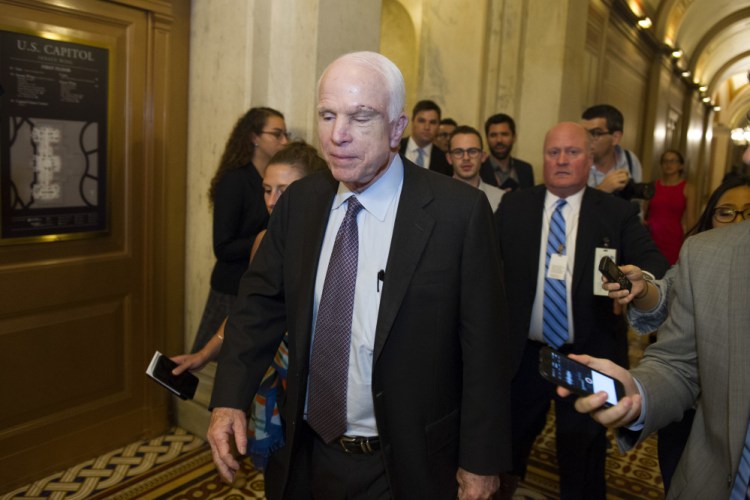 Sen. John McCain, R-Ariz., is pursued by reporters after casting a 'no' vote on a measure to repeal parts of former President Barack Obama's health care law.