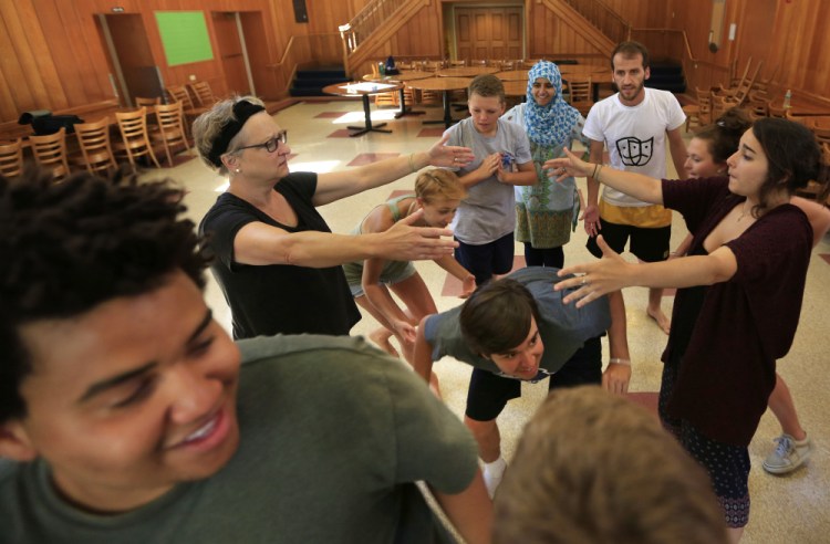 In this Wednesday, July 26, 2017, photo, participants role-play in a drama therapy workshop at Project Common Bond, a summer camp being held at Colby College in Waterville, Maine. The project seeks to create a new generation of socially conscious adults by bringing together young people impacted by violent trauma.
