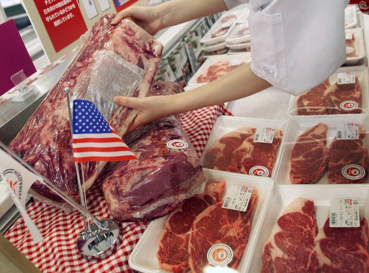 A store employee at Jusco Supermarket arranges U.S. beef products in Tokyo in this 2008 photo. Japan's Finance Minister Taro Aso said Friday his country is slapping emergency tariffs of 50 percent on imports of frozen U.S. beef after shipments surged.