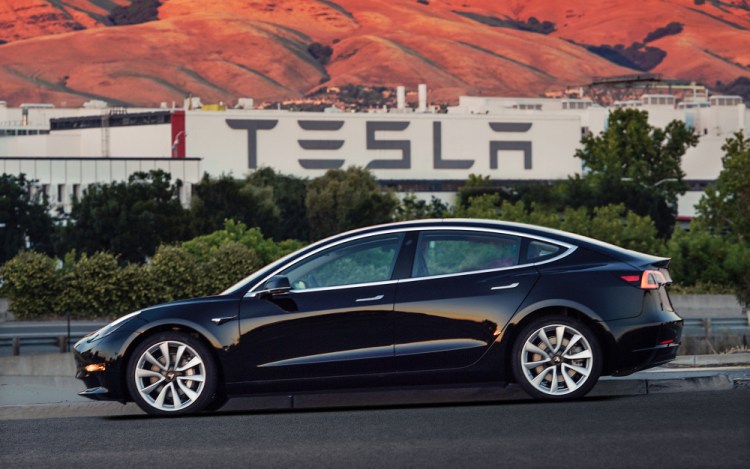 This undated image provided by Tesla Motors shows the Tesla Model 3 sedan. The electric car company's newest vehicle, the Model 3, which was going to its first 30 customers late Friday, is half the cost of previous models. Its $35,000 starting price and 215-mile range could bring hundreds of thousands of customers into Tesla's fold, taking it from a niche luxury brand to the mainstream.