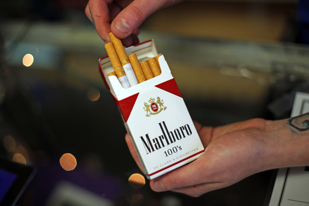 FILE - This July 17, 2015, file photo, shows a pack of Marlboro cigarettes, an Altria brand, at a Smoker Friendly shop in Pittsburgh. Altria Group reports earnings, Thursday, July 27, 2017. (AP Photo/Gene J. Puskar, File)