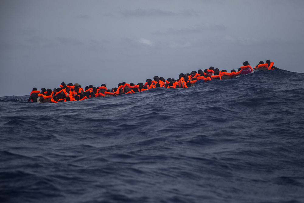 Sub saharan migrants wait to be rescued by aid workers of Spanish NGO Proactiva Open Arms in the Mediterranean Sea, about 15 miles north of Sabratha, Libya on Tuesday, July 25, 2017. More than 120 migrants were rescued Tuesday from the Mediterranean Sea while 13 more ‚Äîincluding pregnant women and children‚Äî died in a crammed rubber raft, according to a Spanish rescue group. (AP Photo/Santi Palacios)