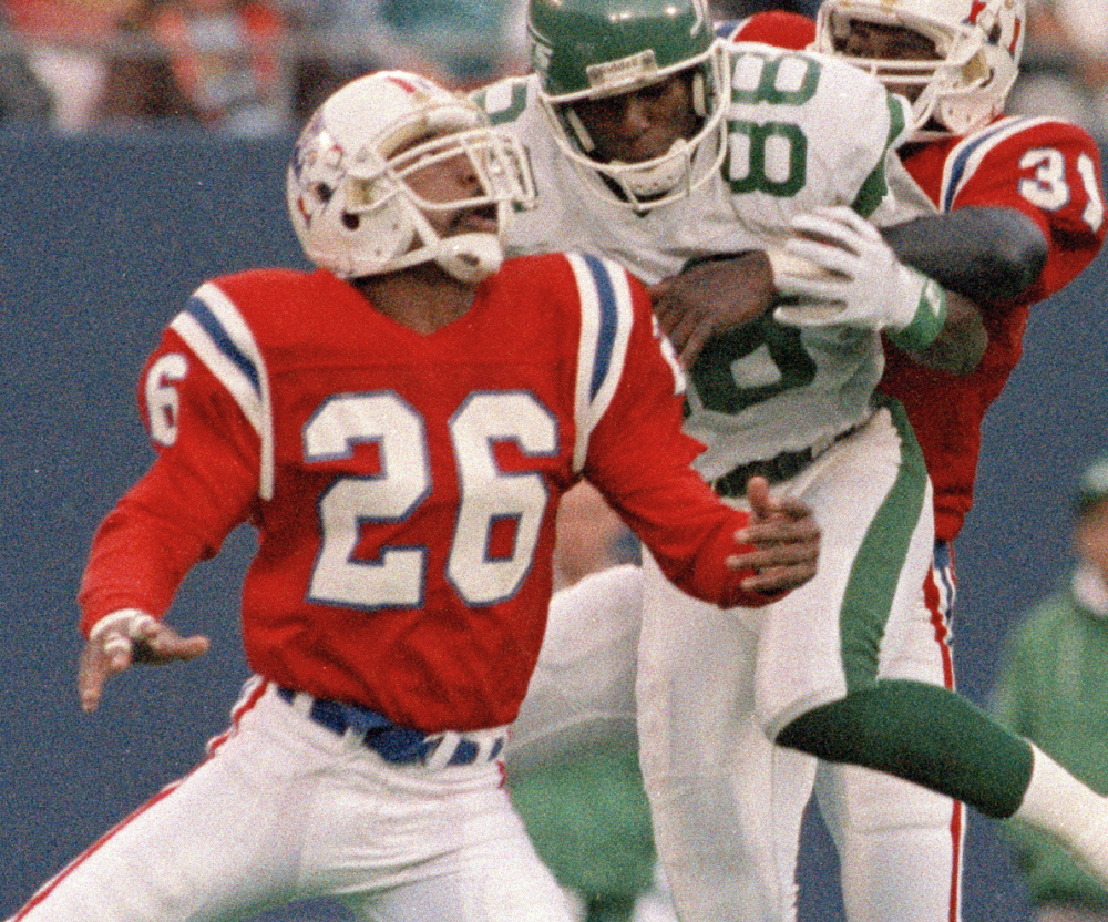 Raymond Clayborn, left, and Fred Marion of the Patriots put a hit on Jets receiver Al Toon on Nov. 14, 1988. Clayborn was inducted Saturday into the team's Hall of Fame.