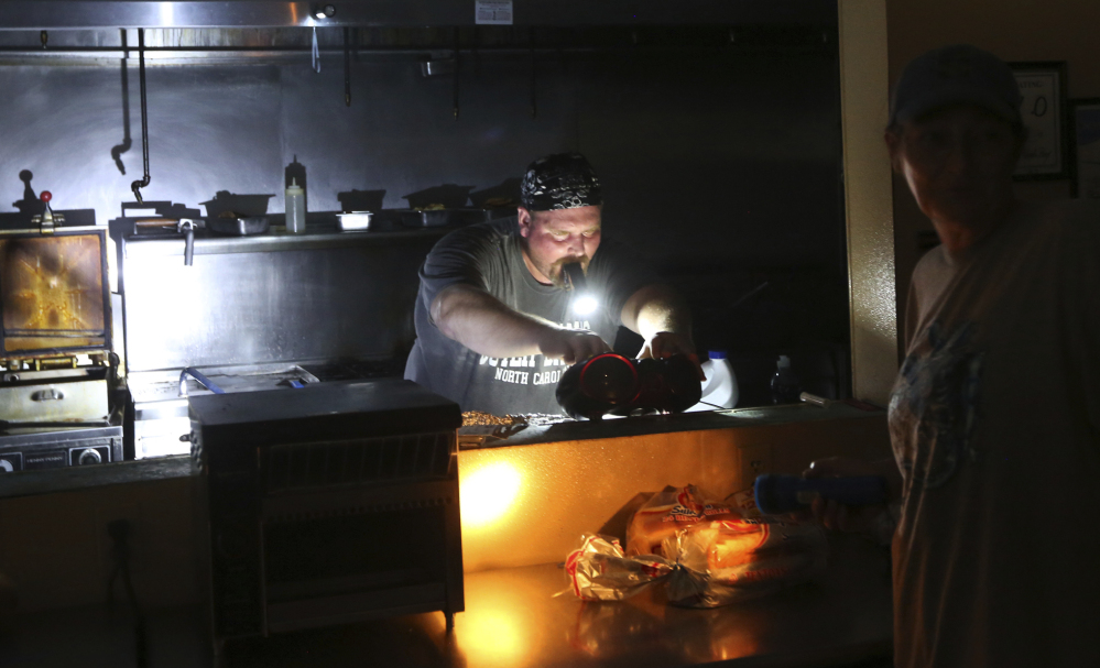 Aaron Howe is forced to cook in the dark kitchen at his store.